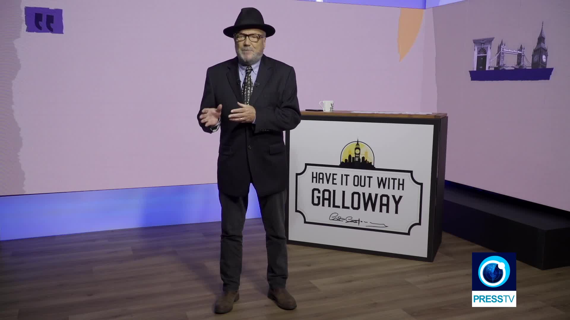 George Galloway presenting Have It Out with Galloway in its studio, with the programme identity on the desk.